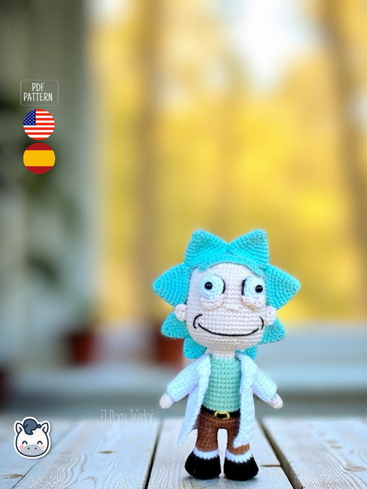 Rick and Morty amigurumi crochet dolls with white lab coat, blue spiky hair and iconic expressions, displayed on a natural background.