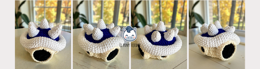 Crochet Amigurumi of the Blue Spiny Shell from Mario Kart made with soft blue and white yarn.
