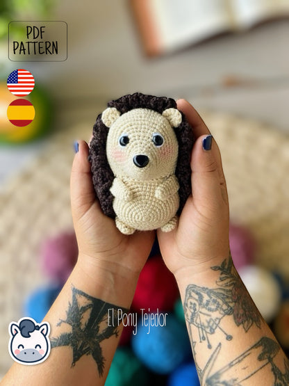 This Hedgehog crochet pattern PDF is a handmade geek amigurumi plush toy inspired by cute woodland animals. This kawaii-style crochet pattern includes a detailed step-by-step photo tutorial to help you create your own adorable spiky hedgehog plush. Perfect for nature lovers, geek collectors, and handmade enthusiasts. Available in English and Spanish as a digital instant download for your next cozy crochet project.