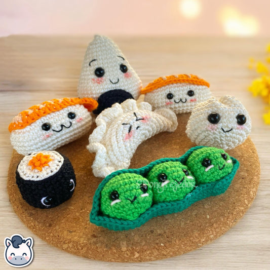 This Sushi, Edamame, Dumpling, and Gyoza crochet pattern PDF is a handmade geek amigurumi plush set inspired by cute Japanese food. This kawaii-style crochet pattern includes step-by-step photo tutorials to help you create your own adorable sushi roll, edamame bean, dumpling, and gyoza plush toys. Perfect for food lovers, geek collectors, and handmade enthusiasts. Available in English and Spanish as a digital instant download.