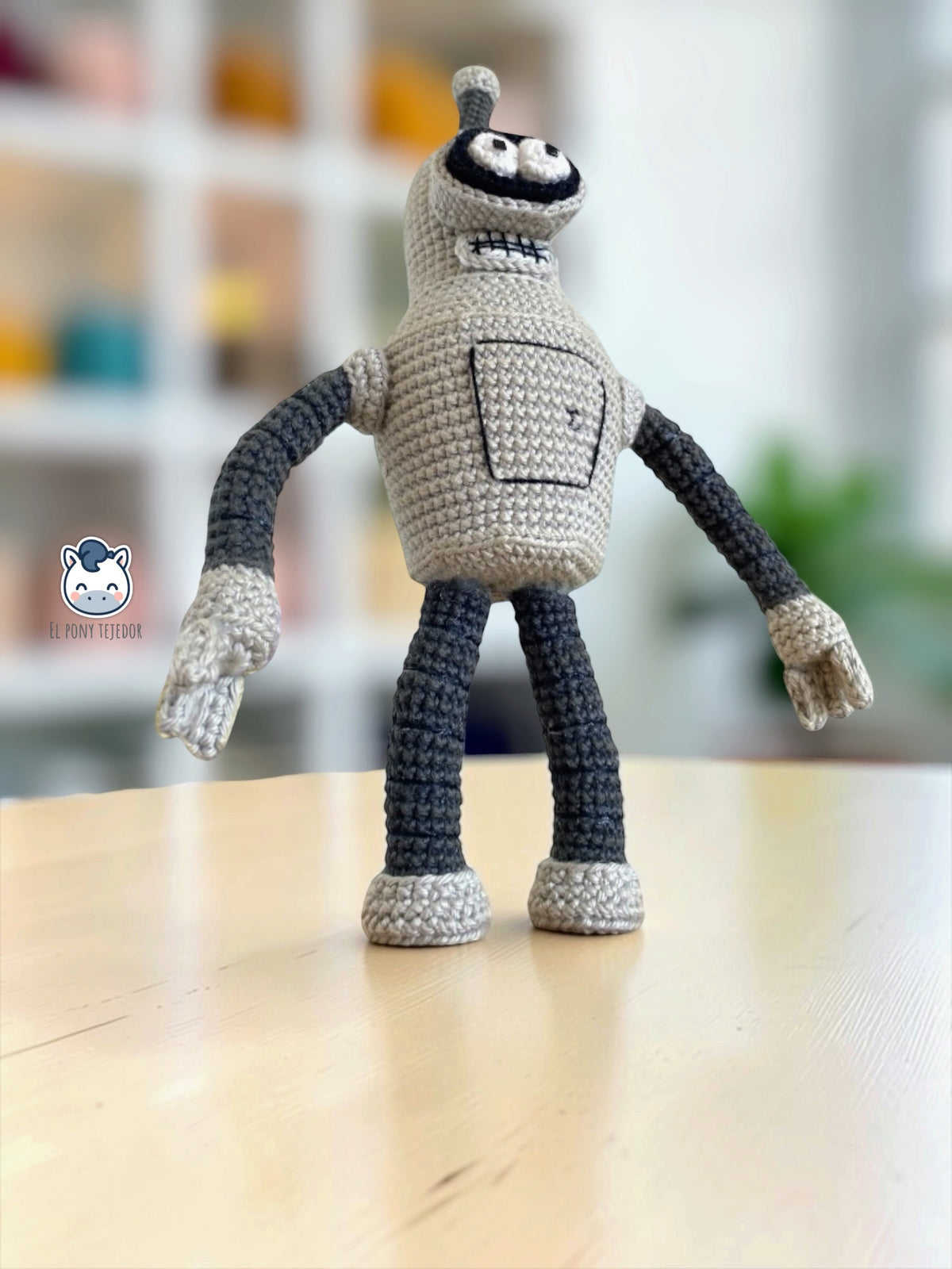 Handmade Bender crochet amigurumi inspired by Futurama, featuring his distinctive grey robot body, antenna, large eyes and square-toothed smile. PDF crochet pattern for Futurama fans, science fiction lovers and crochet character collectors.