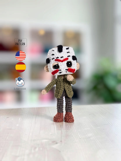 Amigurumi de Jason Voorhees hecho a mano a ganchillo, inspirado en Viernes 13, con su icónica máscara blanca de hockey, chaqueta verde y pantalones oscuros. Patrón PDF de crochet ideal para Halloween y coleccionistas del cine de terror.