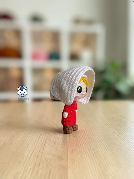 June amigurumi crochet pattern inspired by The Handmaid’s Tale, featuring a doll with a red dress and white bonnet.