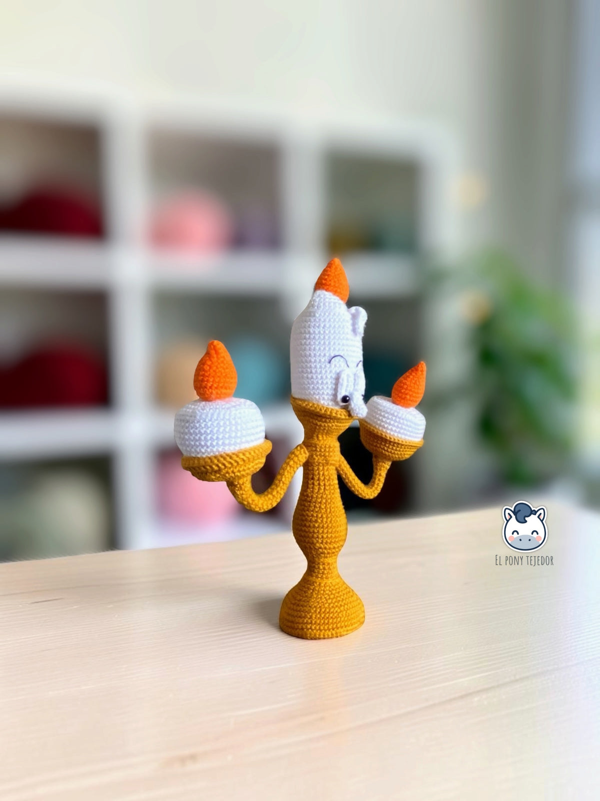 Handmade Lumière amigurumi inspired by Disney’s Beauty and the Beast, featuring three orange candle flames, a detailed crochet design and poseable arms. A magical crochet pattern PDF for Disney fans and amigurumi lovers.
