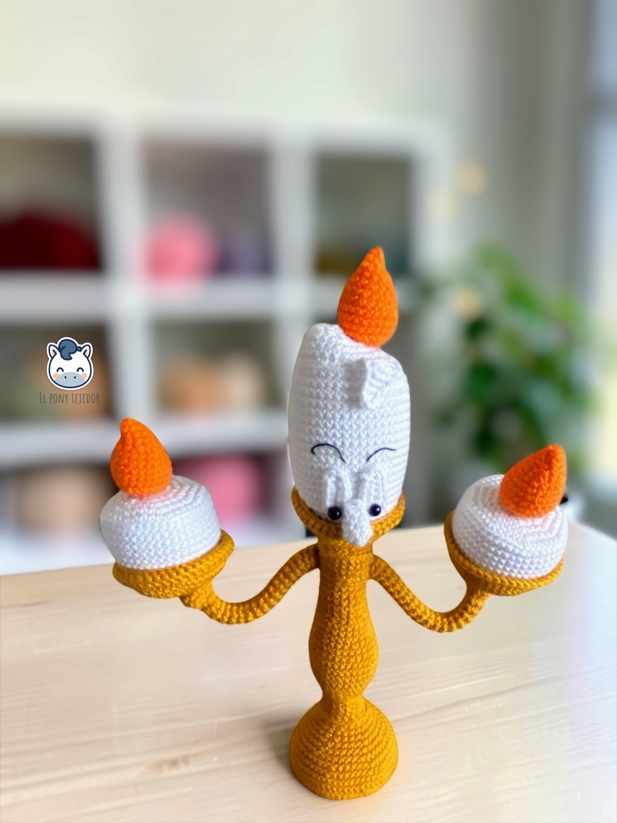 Handmade Lumière amigurumi inspired by Disney’s Beauty and the Beast, featuring three orange candle flames, a detailed crochet design and poseable arms. A magical crochet pattern PDF for Disney fans and amigurumi lovers.