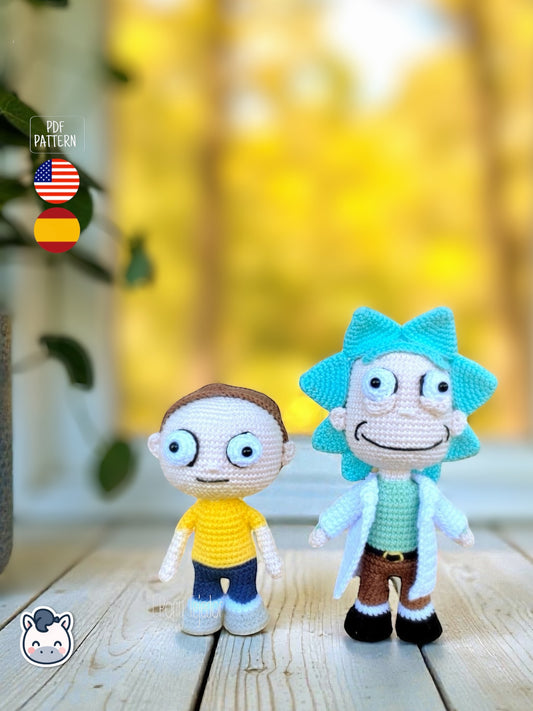 Rick and Morty amigurumi crochet dolls with white lab coat, blue spiky hair and iconic expressions, displayed on a natural background.