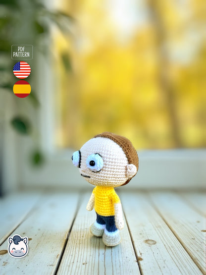 Rick and Morty amigurumi crochet dolls with white lab coat, blue spiky hair and iconic expressions, displayed on a natural background.