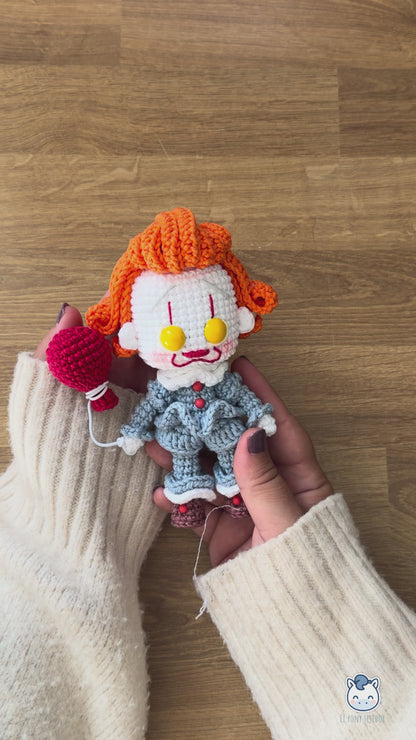 Amigurumi de Pennywise inspirado en IT, un patrón PDF de crochet con estilo Funko y su icónico globo rojo, perfecto para fans del cine de terror y la decoración de Halloween.