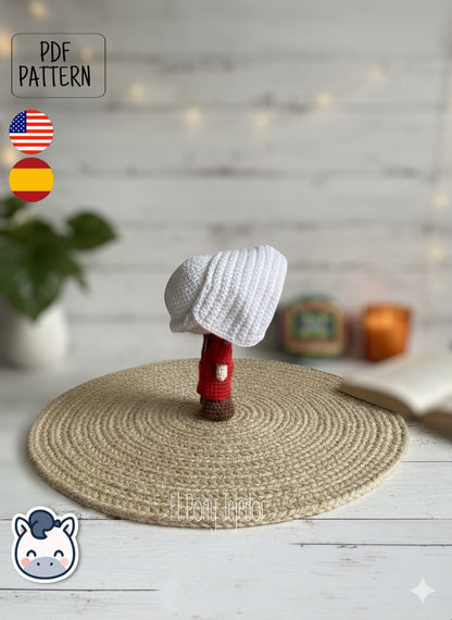 Handmade June Offred amigurumi inspired by Hulu’s The Handmaid’s Tale, a geeky and feminist crochet pattern PDF perfect for fans of dystopian stories, Margaret Atwood, and collectible plush dolls.
