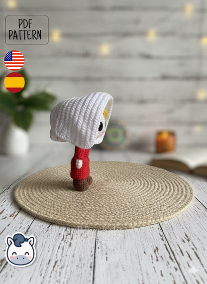 Handmade June Offred amigurumi inspired by Hulu’s The Handmaid’s Tale, a geeky and feminist crochet pattern PDF perfect for fans of dystopian stories, Margaret Atwood, and collectible plush dolls.
